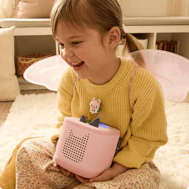 Child listening to Cakey Cat Tonie on a pink Toniebox 2