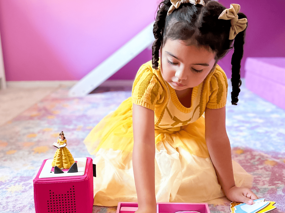 Child playing with Disney Beauty & the Beast Tonie audio figurine and Toniebox 2