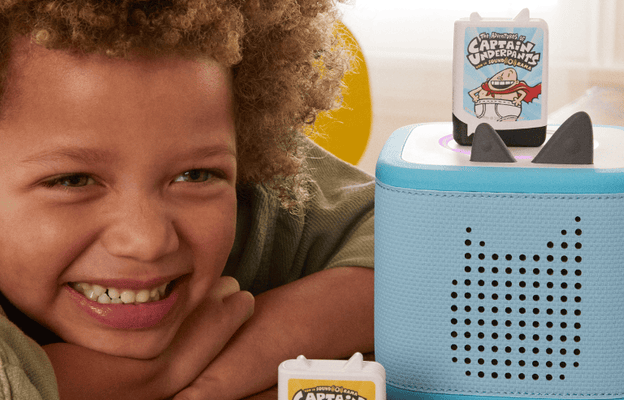 Child listening to Captain Underpants audiobook Tonies on a blue Toniebox 2