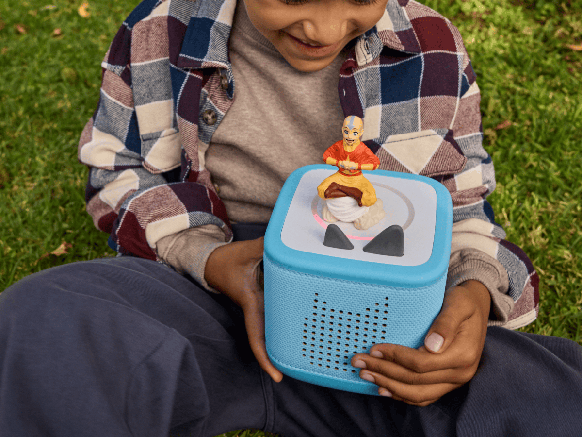 child holding a blue toniebox 2 with Avatar The Last Airbender - Aang Tonie