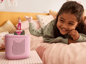 child playing in their bedroom with Barbie You Can Be Anything Tonie on a pink toniebox 2