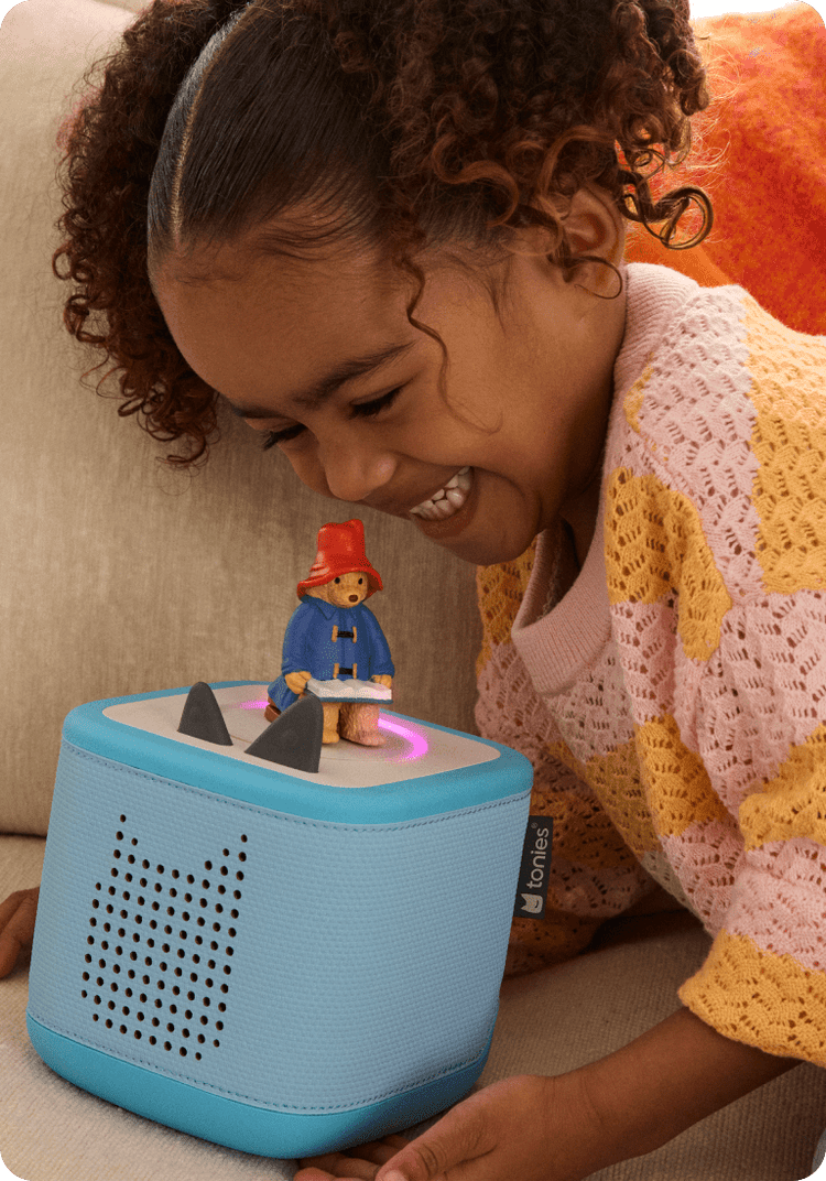 child listening to Paddington Bear Tonie on blue Toniebox 2