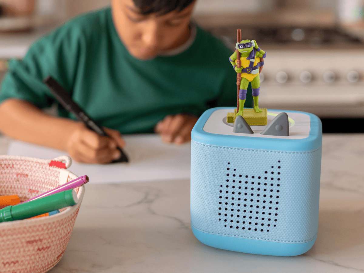 Tales of the Teenage Mutant Ninja Turtles- Donatello Tonie on a blue toniebox 2 with a child coloring in the background
