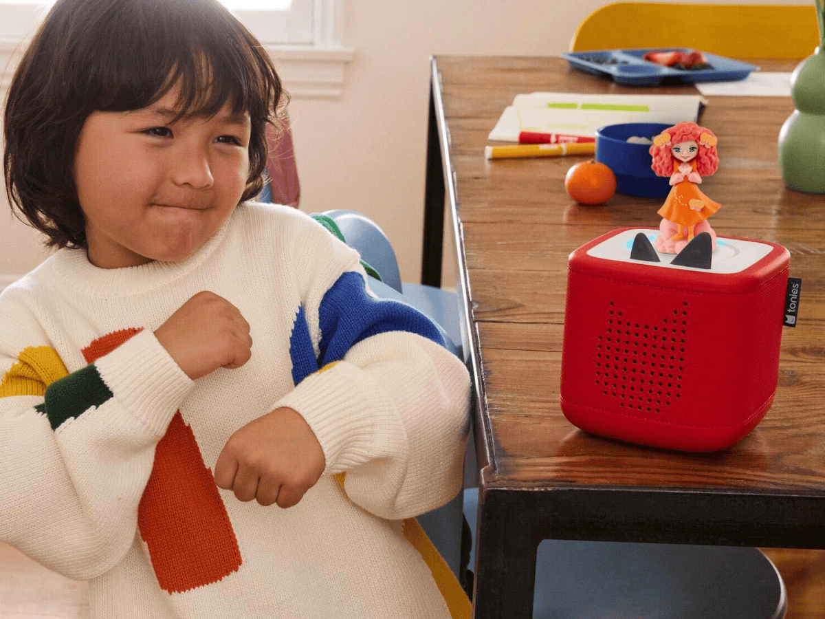 child playing with red toniebox 2 and emma memma tonie