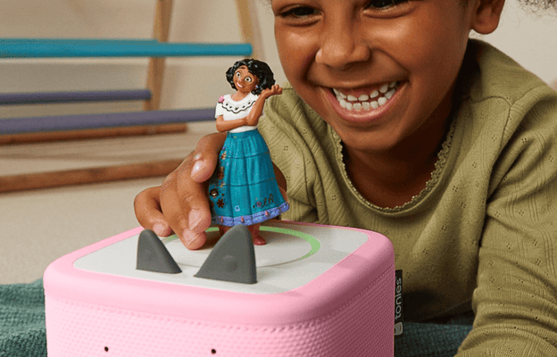 Young girl listening to the Encanto Tonie on a pink Toniebox 2