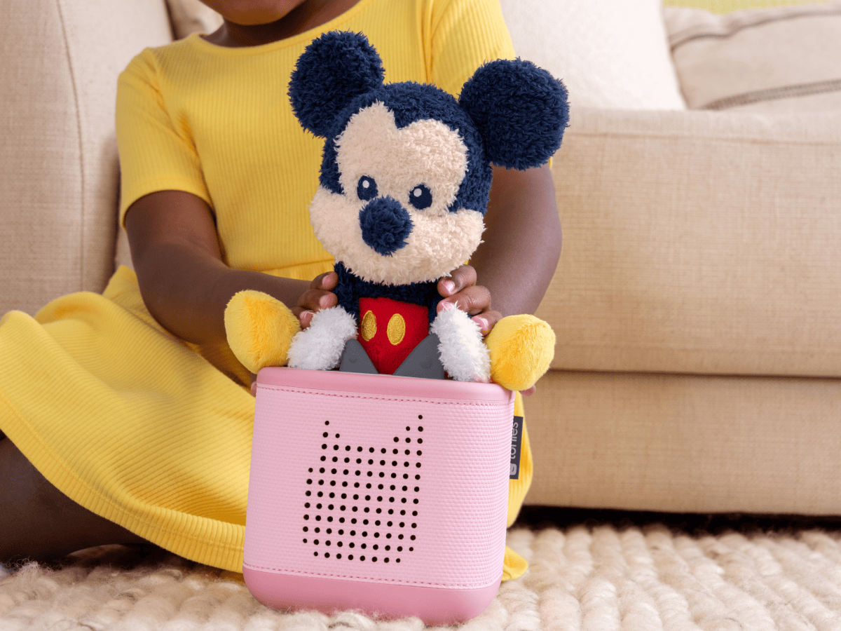 Child playing with Cuddle Tonie Disney Mickey audio figurine and Toniebox 2