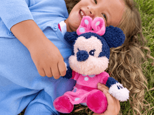 Child playing with Cuddle Tonie Disney Minnie audio figurine and Toniebox 2