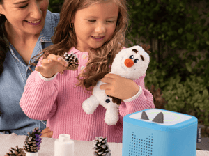 Child playing with Cuddle Tonie Disney Olaf audio figurine and Toniebox 2
