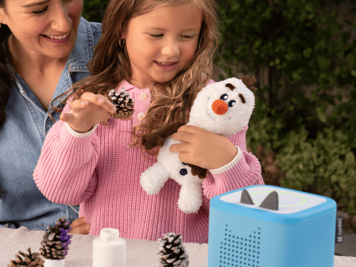 Child playing with Cuddle Tonie Disney Olaf audio figurine and Toniebox 2