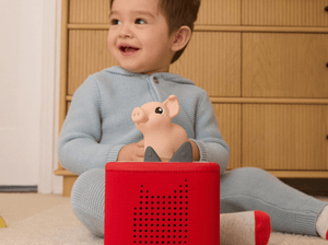 Child playing with My First Tonies Pig audio figurine and Toniebox 2