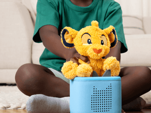 Child playing with Cuddle Tonie Disney Simba audio figurine and Toniebox 2