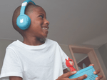 Child Listening To The Toniebox 2 And Tonie With Sky Blue Bluetooth Headphones For Kids
