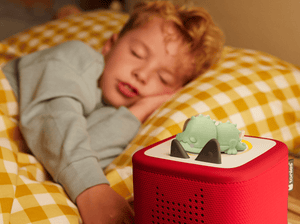 Child sleeping near Sleepy Crocodile_ Bedtime Story from the Sleepy Jungle Tonie audio figurine and Toniebox 2
