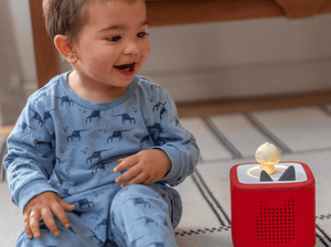 Child Playing With Sleepy Duck Audio Figurine And Toniebox 2