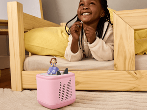 child playing with a pink toniebox 2 and Disney Sofia the First Tonie