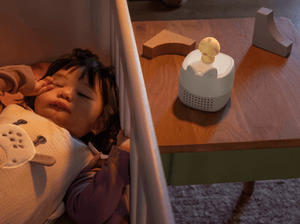 child laying next to the Toniebox Lite Sleepy Friends Set