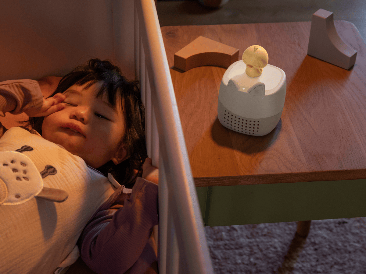 child laying next to the Toniebox Lite Sleepy Friends Set