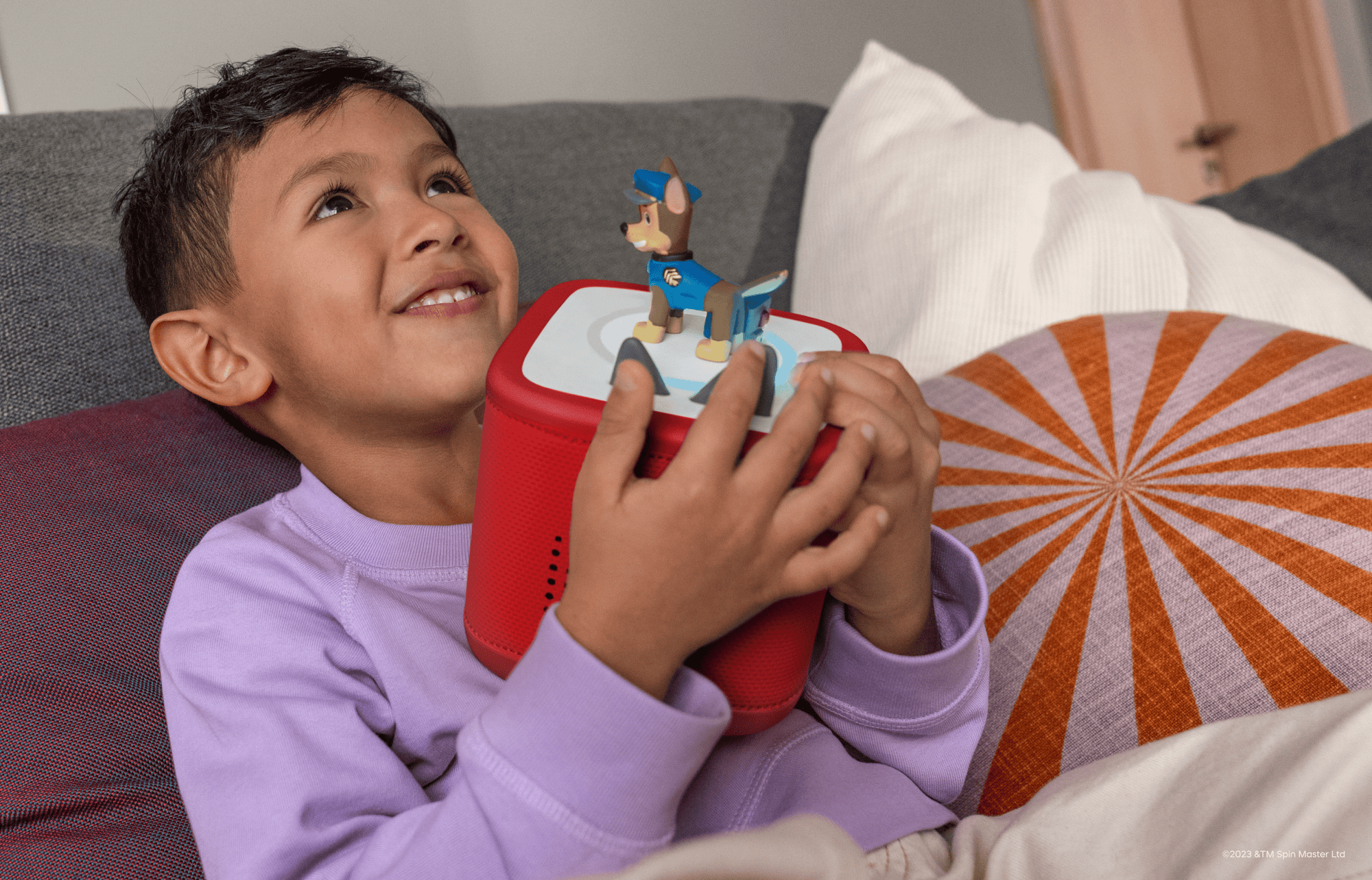 child holding red Toniebox  2 with a Chase Tonie on top