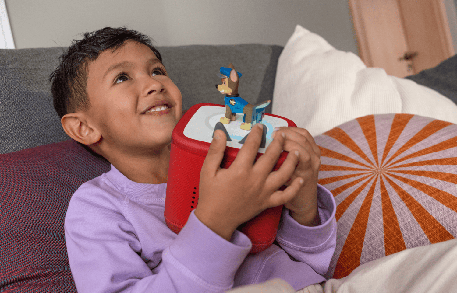 child holding red Toniebox  2 with a Chase Tonie on top