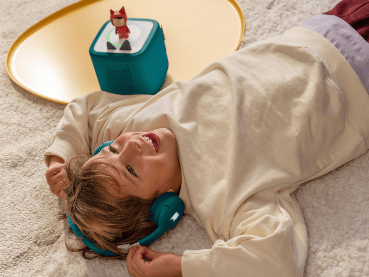 Child Listening To The Toniebox 2 And Tonie With Teal Bluetooth Headphones For Kids