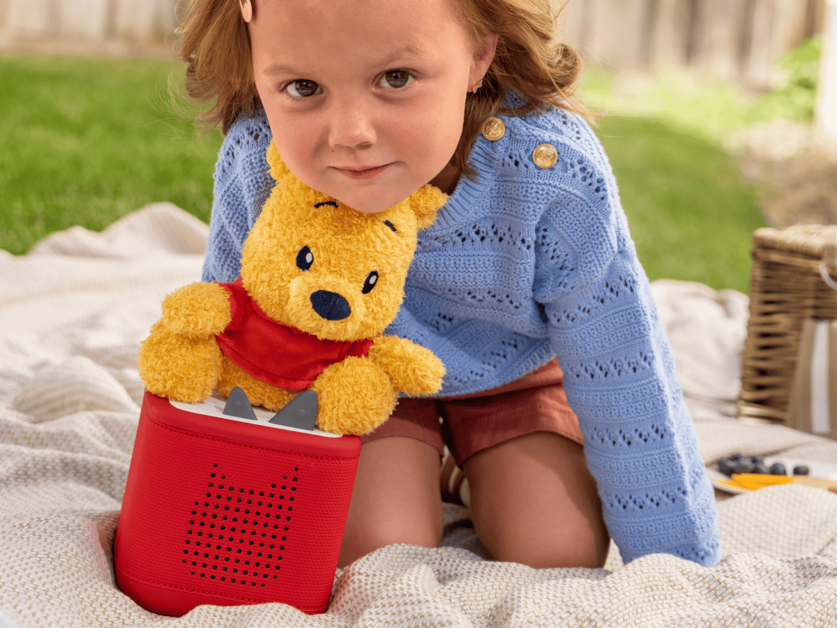 Child playing with Cuddle Tonie Disney Winnie the pooh audio figurine and Toniebox 2