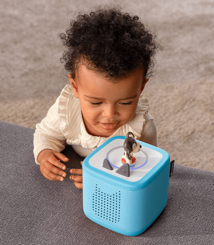 Child listening to a Playtime Puppy Tonie on a blue Toniebox 2