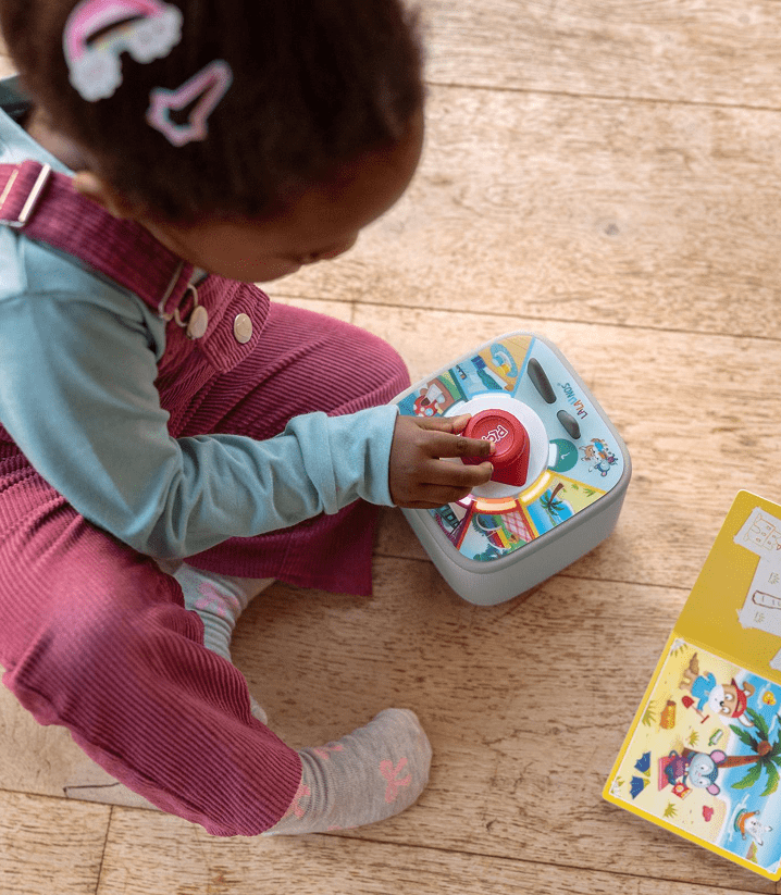 Child playing a Tonieplay game with a blue Toniebox 2