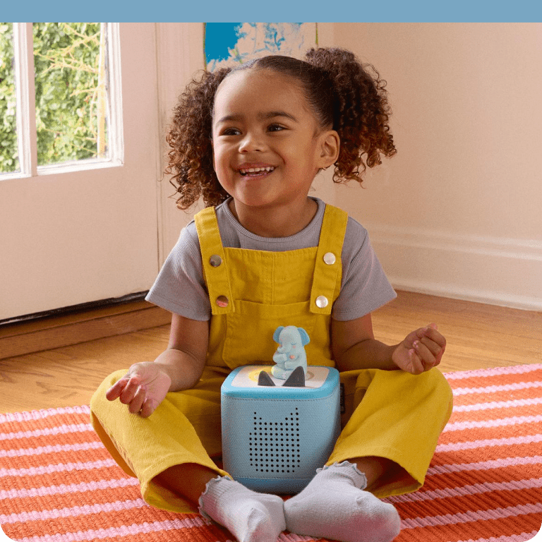 Child listening to Great the Elephant Tonie on a blue Toniebox 2