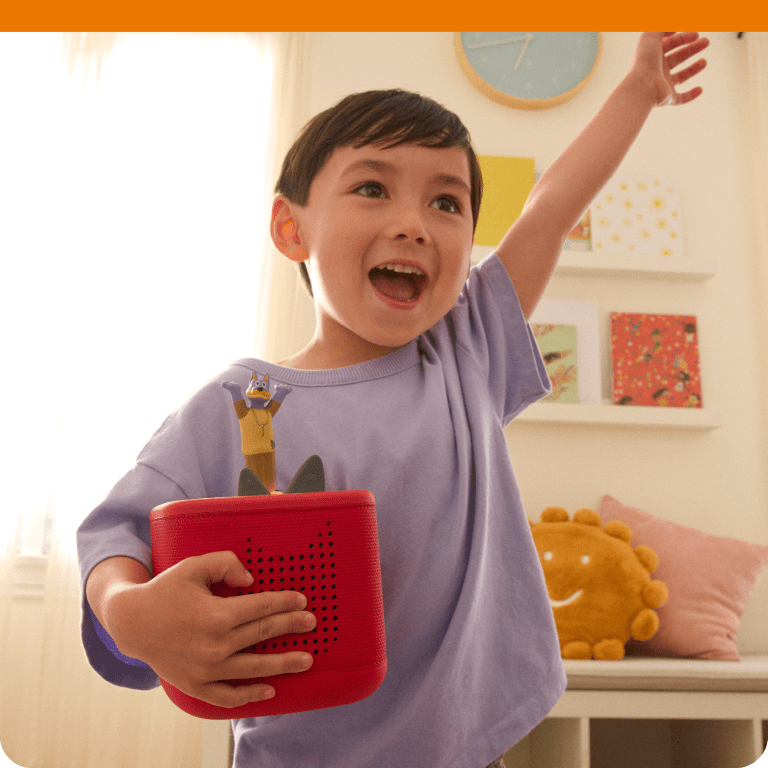 Child listening to Doggyland Tonie on a red Toniebox 2