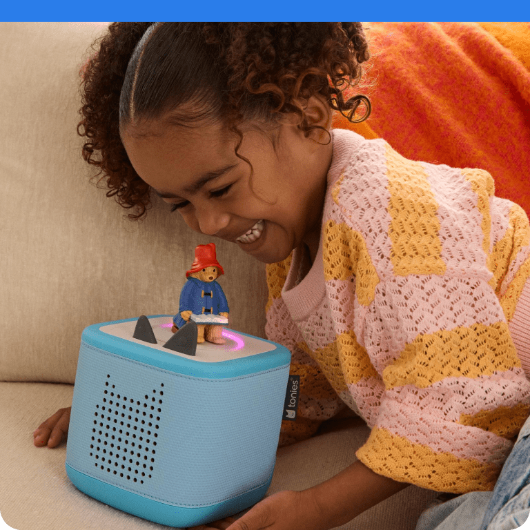 Child listening to Paddington Bear Tonie on a blue Toniebox 2