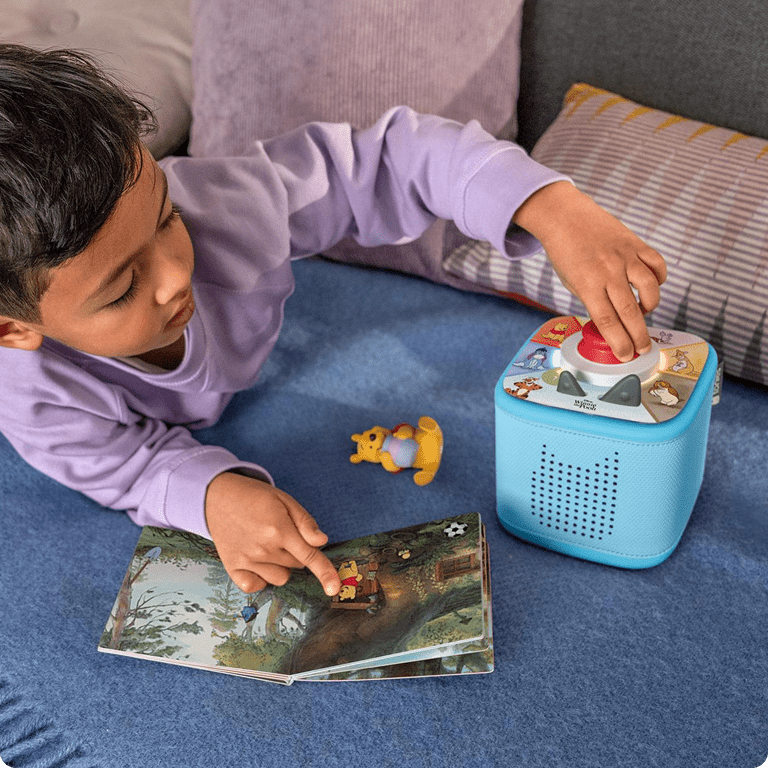 Child playing Winnie the Pooh Tonieplay game on a blue Toniebox 2