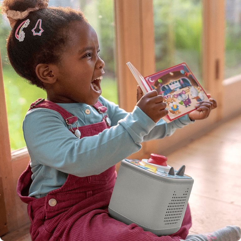 child playing Tonieplay game on a grey Toniebox 2